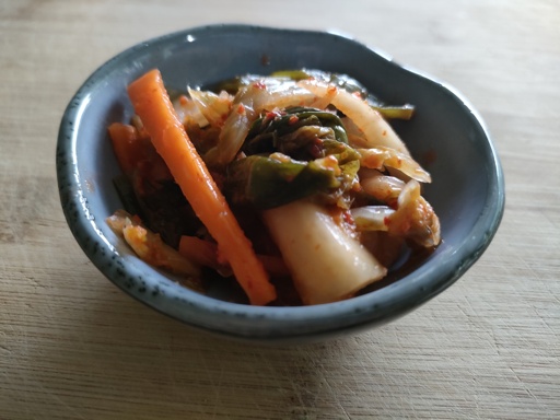 homemade kimchi in a small blue round side dish