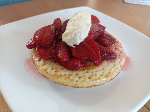 Homemade jumbo crumpet with baked strawberries topped with mascarpone