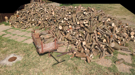 Photo 1: a large pile of firewood on a grassy area with a half-loaded handcart next to it. Photo 2: firewood stacked inside a shed.