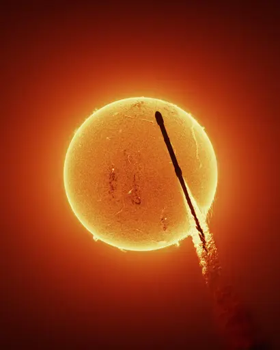 Falcon 9 silhouette in front of the sun with details in both the sun and the rocket